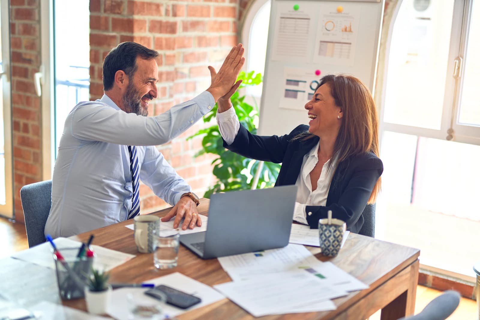 Two professionals reviewing financial documents together at a modern office desk