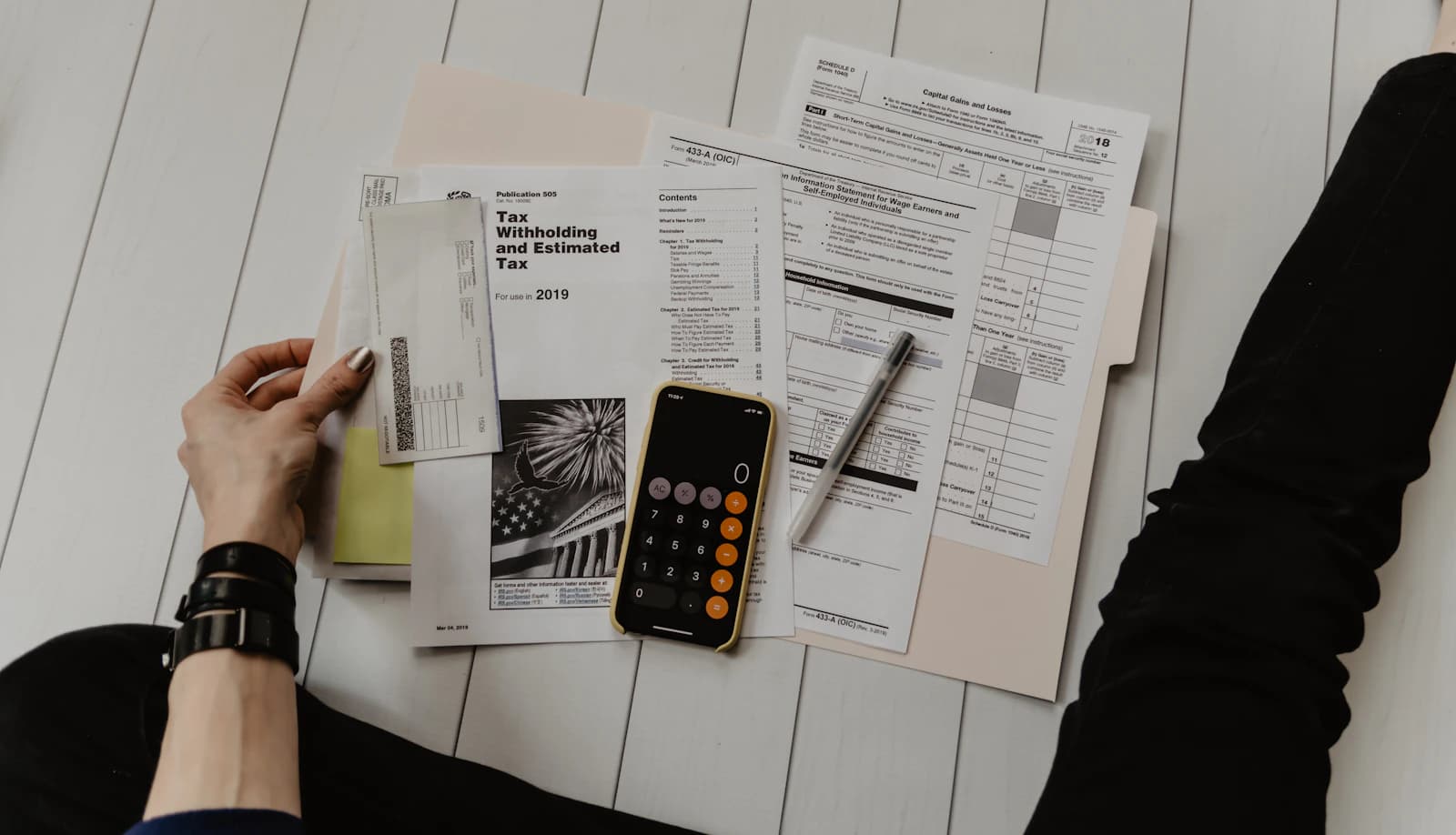 Canadian business owner reviewing HST registration requirements at a desk with documents